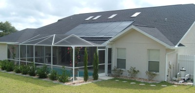 Solar pool panels installed on roof of house